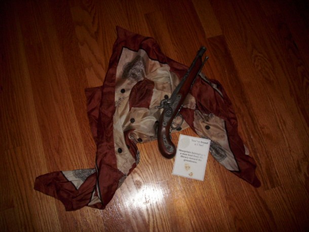 A woman's scarf, an antique pistol, and a statement...